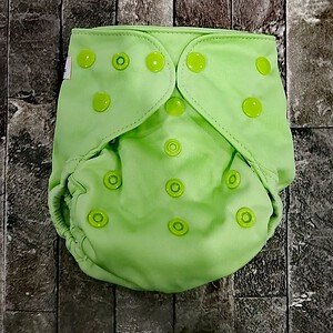 Bright lime green cloth diaper with adjustable snaps, perfect for eco-friendly baby care.