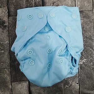 1. Reusable cloth nappy in light blue with adjustable snap closures, eco-friendly baby diaper.